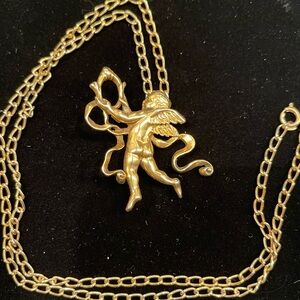 Vintage Metropolitan Museum of Art gold-toned cherub brooch/pendant necklace.